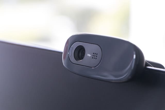 Image shows a small webcam on top a computer screen.
